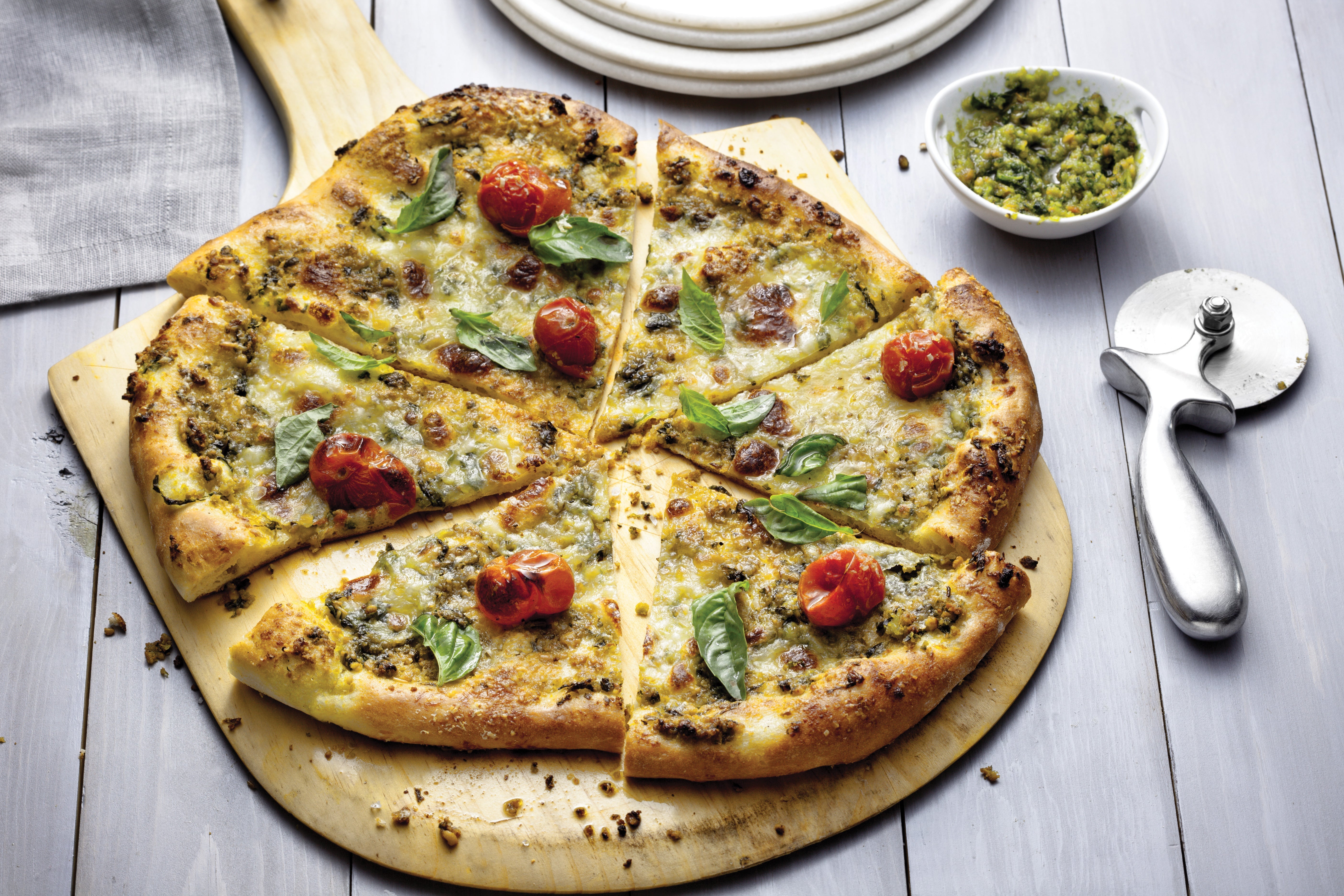Homemade Pizza with Mozzarella, Cherry Tomatoes, and Pesto